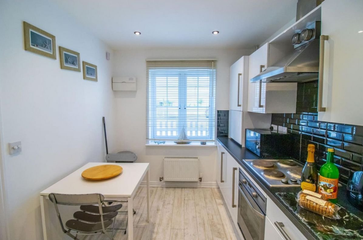 Breakfast table in the kitchen at Beachside Cottage looking towards the garden window